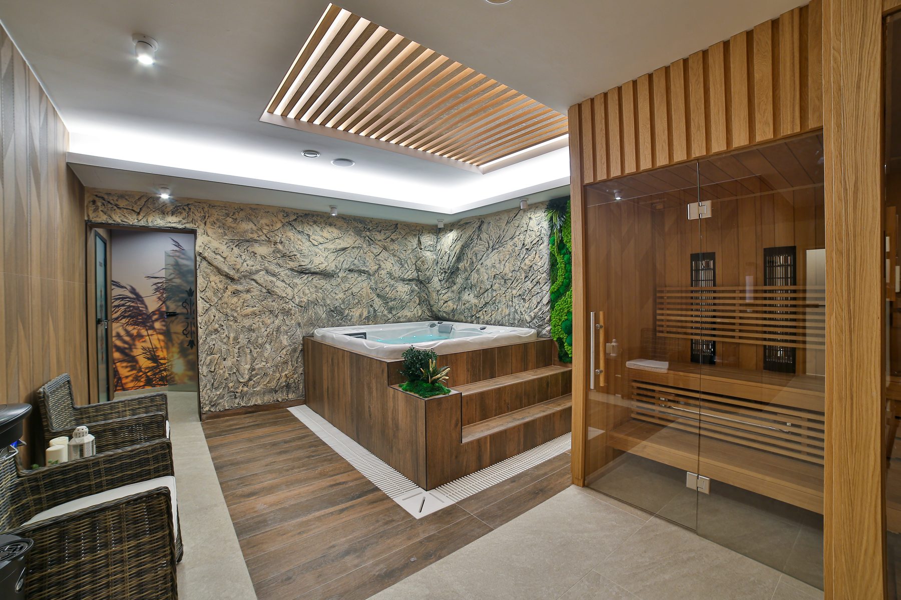 Gabinet VIP w Hotelu Jawor — jacuzzi przy ścianie skalnej, obok sauna za szklaną ścianą i fotele w strefie relaksu