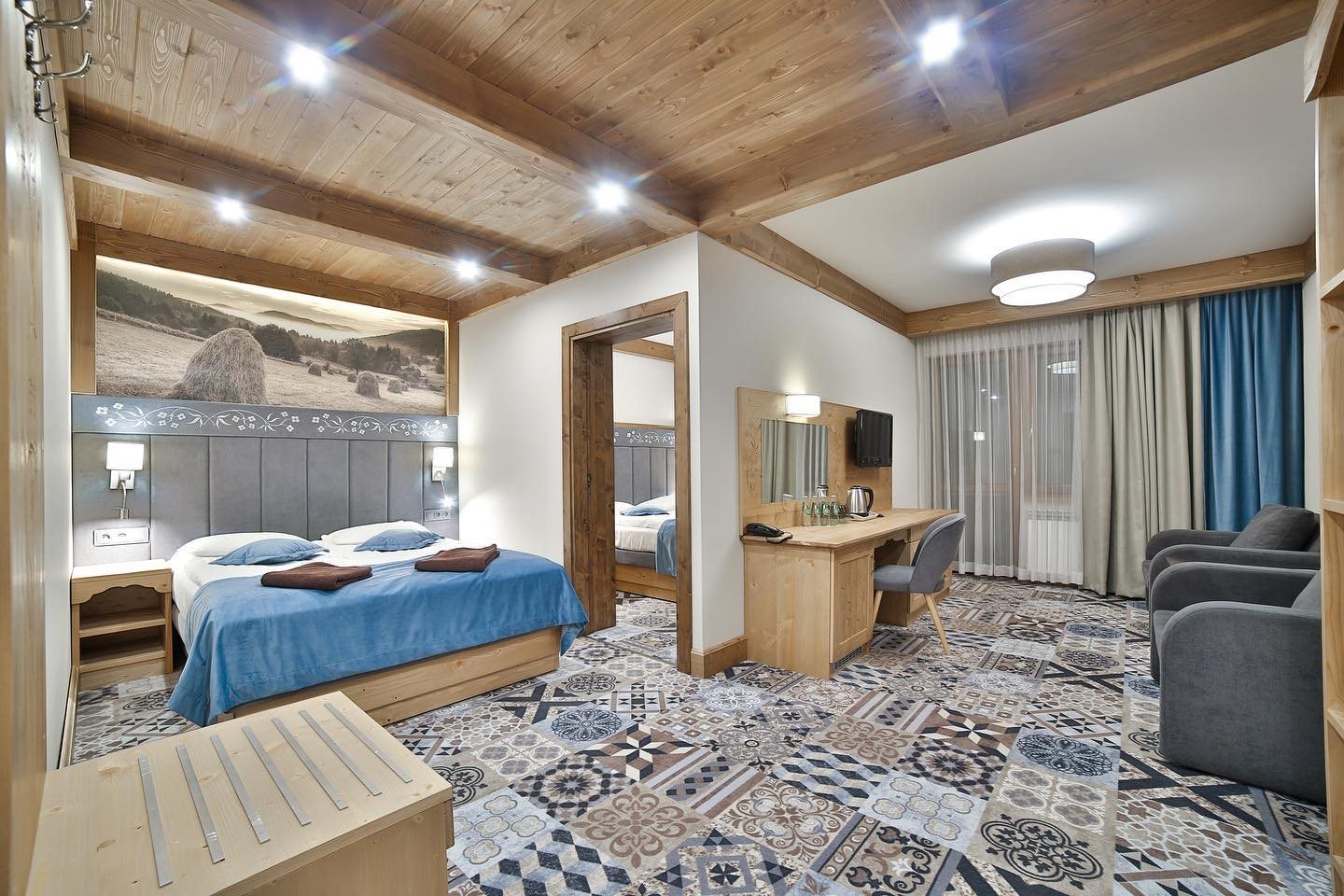 Studio Deluxe w Hotelu Jawor — łóżko w pierwszym pokoju i przejście do drugiego